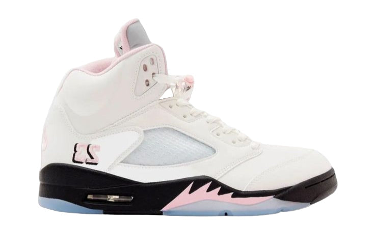 White sneaker with pink accents on a white background